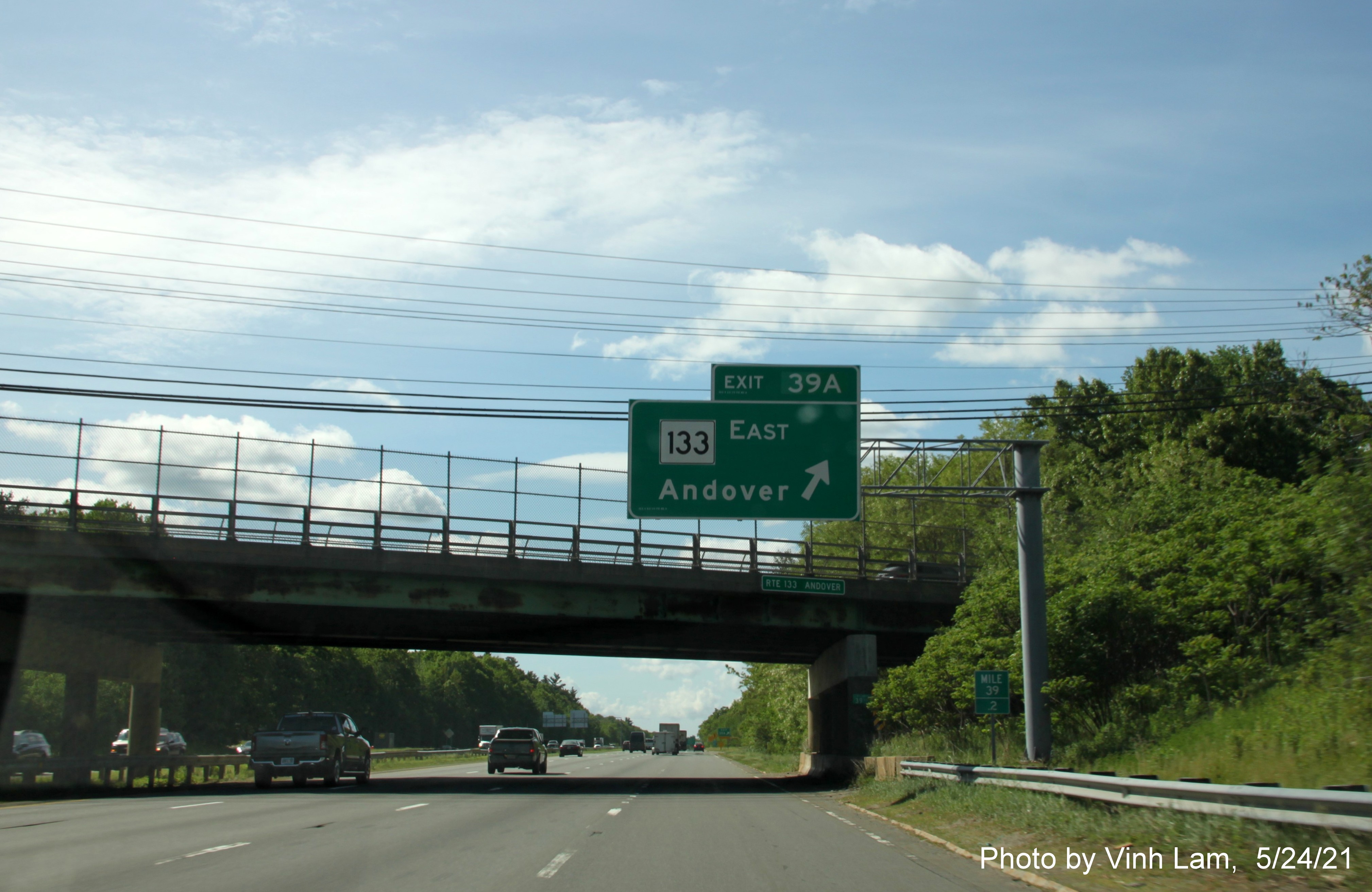 Image of overhead ramp sign for MA 133 East exit with new milepost based exit number on I-93 South in Andover, by Vinh Lam, May 2021