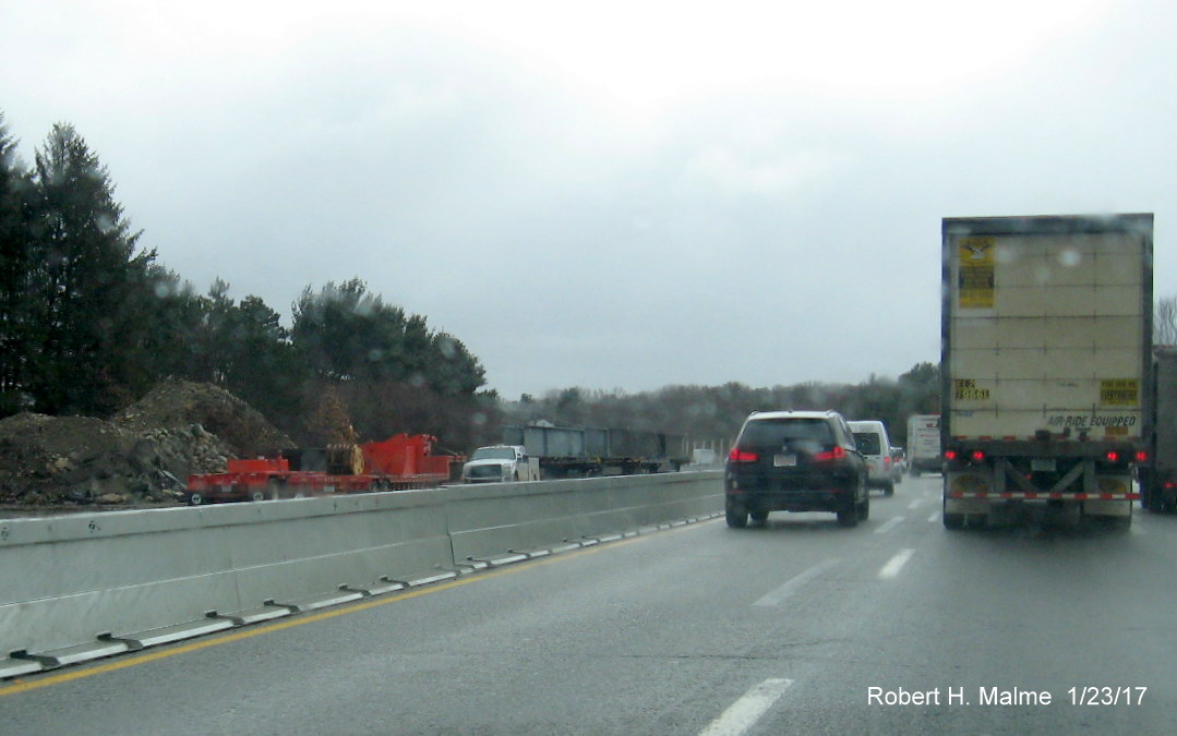 Image of metal support beams for future Highland Ave bridge being stored in I-95 median in Needham