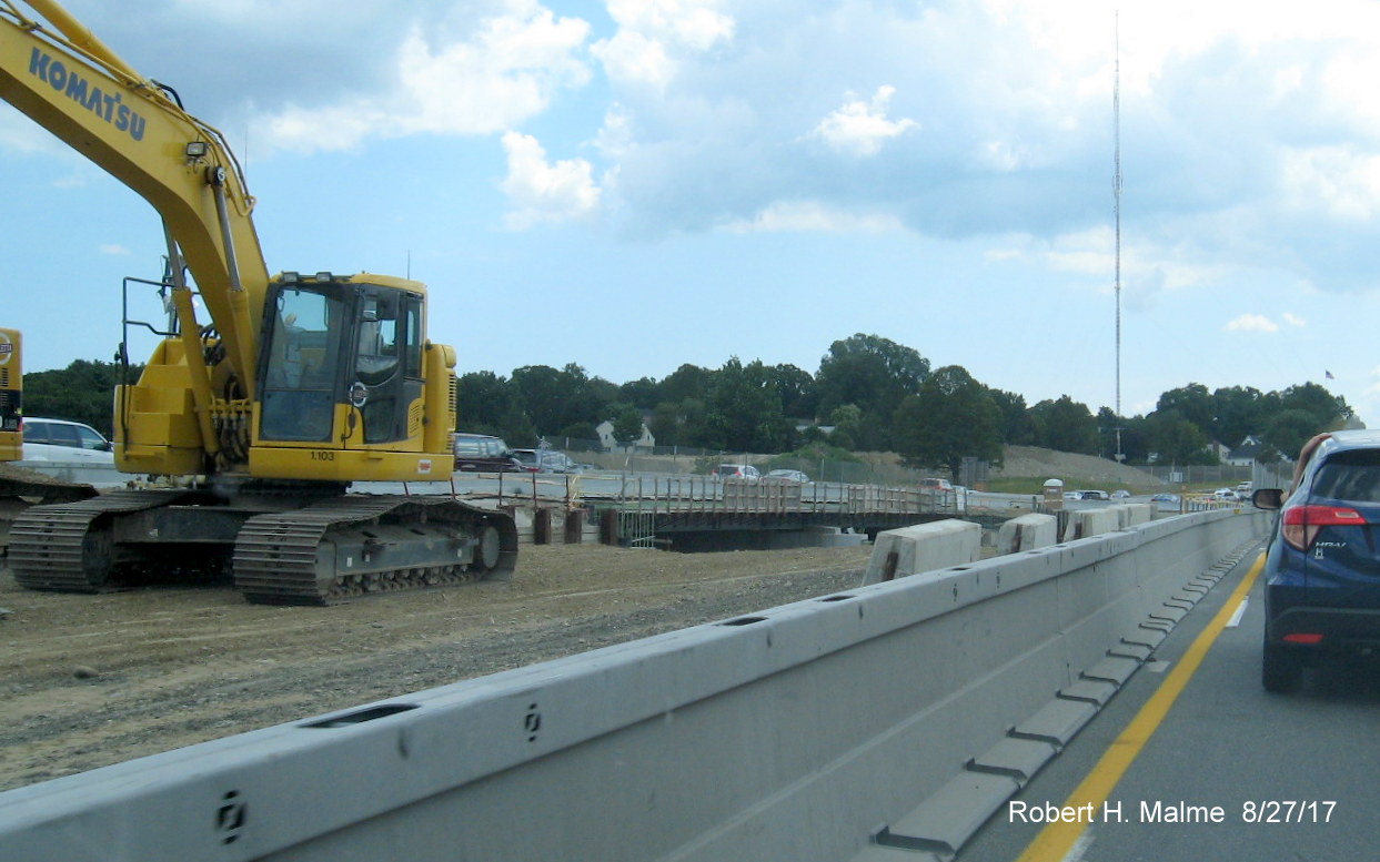 Image of construction equipment for new MA 9 bridge in between split lanes of I-95 South traffic in Add-A-Lane Project work zone in Wellesley