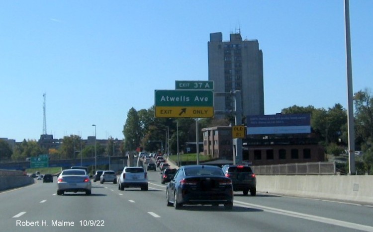 Image of overhead ramp sign for Atwells Avenue exit with new milepost based exit number and yellow Old Exit 21 sign on support on I-95 South in Providence, October 2022