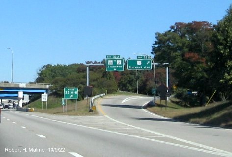 Image of overhead ramp signs for both US 1 Elmwood Avenue and RI 10 exits with new milepost based exit numbers on I-95 North in Cranston, October 2022