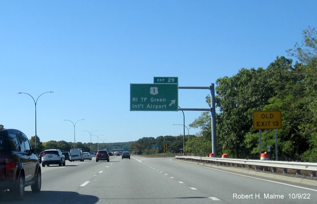 Image of overhead ramp sign for US 1/T.F. Green Airport Connector exit with new milepost based exit number and yellow Old Exit 13 sign on gantry arm on I-95 South in Warwick, October 2022