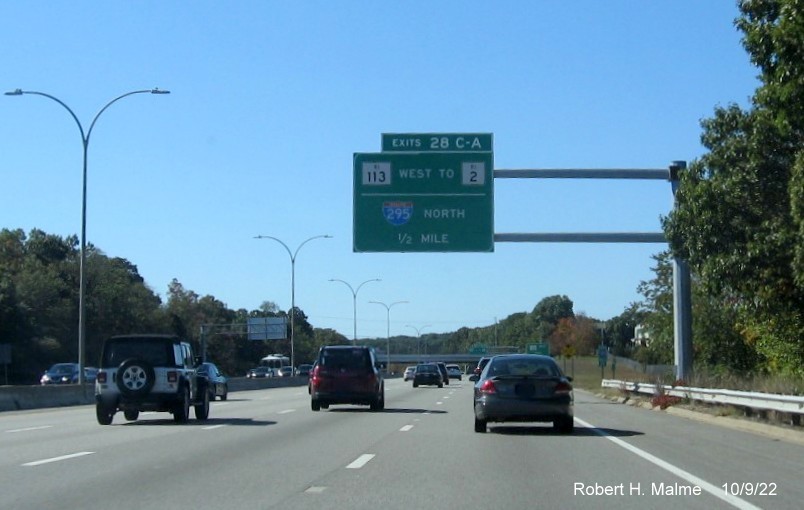Image of 1/2 mile advance overhead sign for RI 113 and To I-295 North exits with new milepost based exit number on I-95 South in Warwick, October 2022
