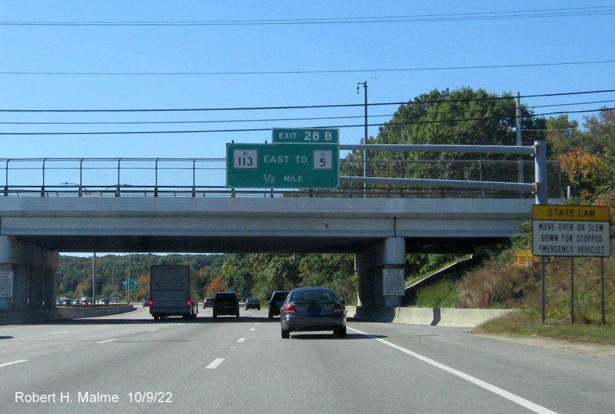 Image of overhead ramp sign for RI 113 exit with new milepost based exit number on I-95 South in Warwick, October 2022