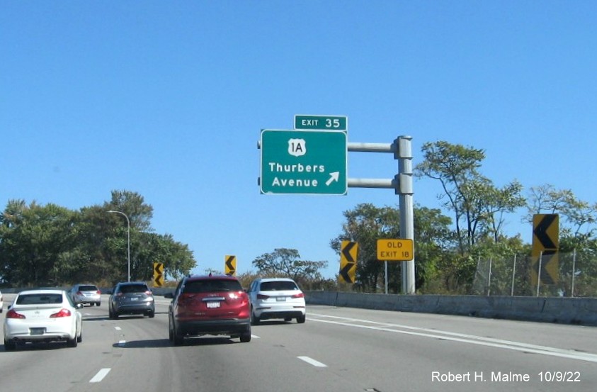 Image of overhead ramp sign for US 1A exit with new milepost based exit number and separate yellow Old Exit 18 sign, on I-95 North in Providence,  October 2022