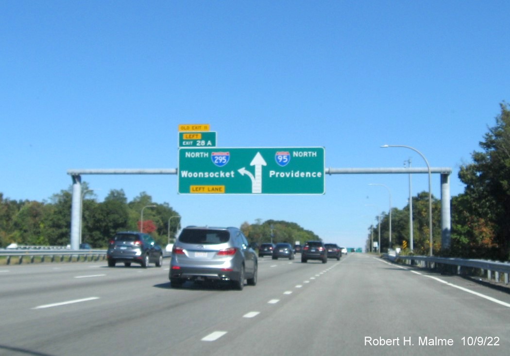Image of 1/2 mile advance diagrammatic overhead sign for I-295 North exit with new milepost based exit number and yellow Old Exit 11 sign above exit tab on I-95 North in Warwick, October 2022