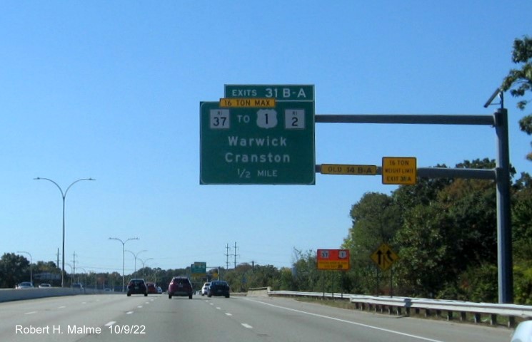 Image of 1/2 mile advance overhead sign for RI 37 exits with new milepost based exit numbers on I-95 South in Warwick, October 2022