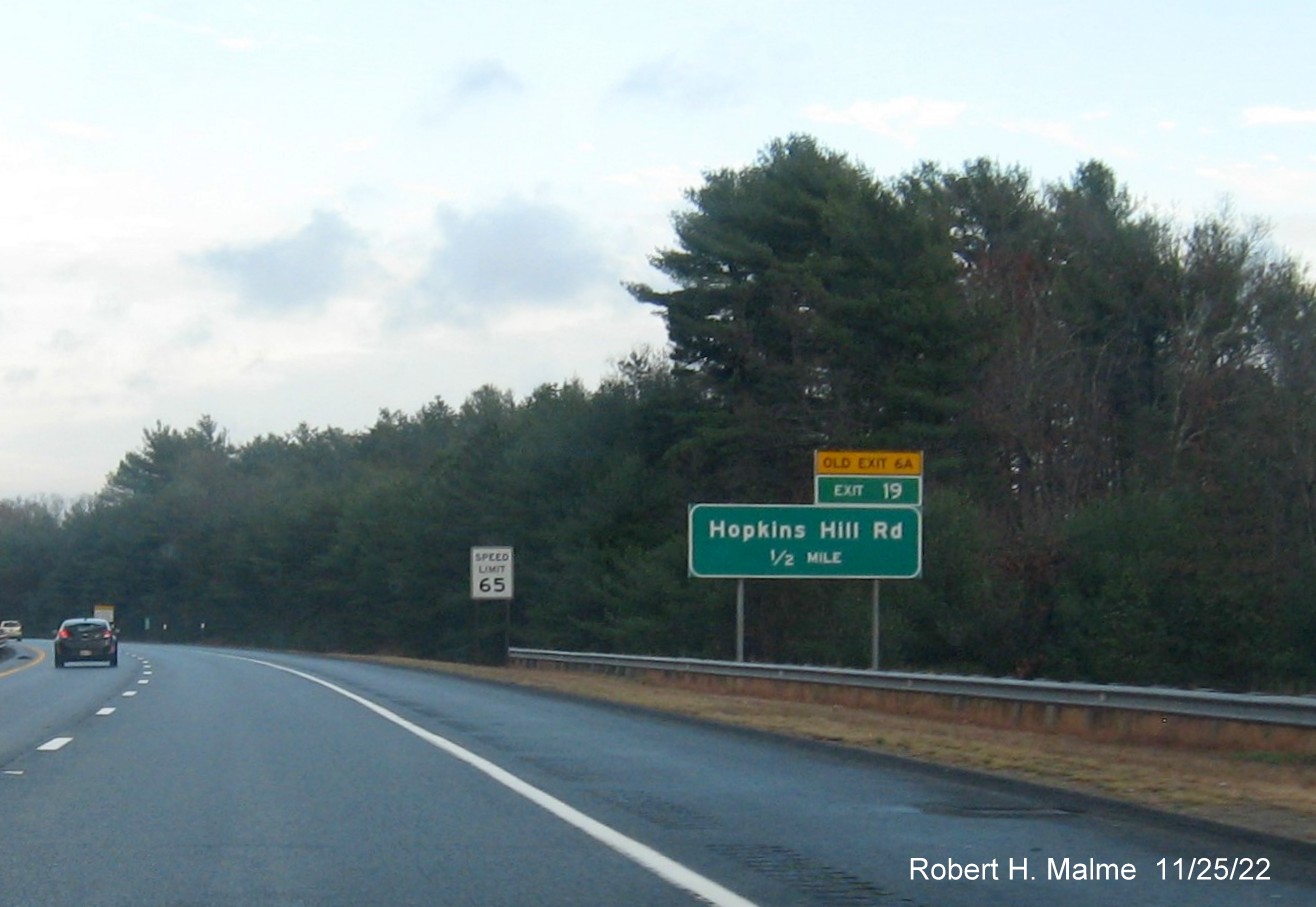 Image of ground mounted 1/2 mile advance sign for Hopkins Hill Road with new milepost based exit number and yellow Old Exit 6A on top of exit tab on I-95 North in West Greenwich, November 2022