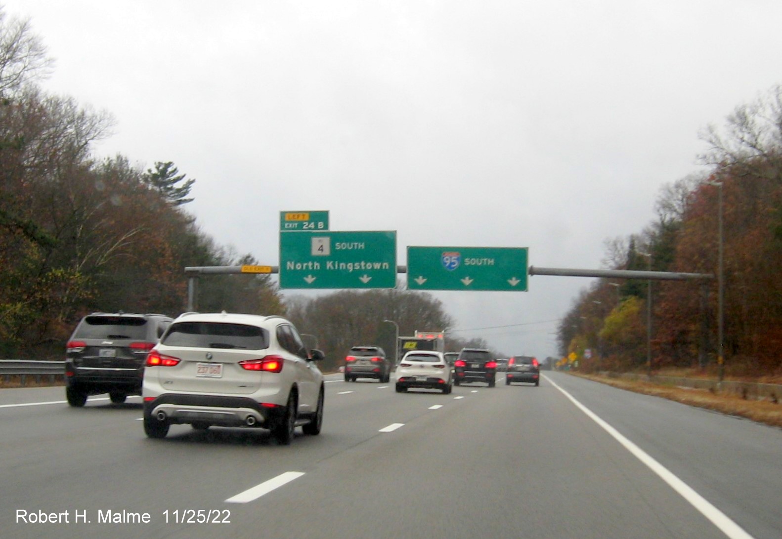 Image of overhead ramp sign for RI 4 South exit with new milepost based exit number and yellow Old Exit 9 advisory sign over exit tab on I-95 South in Warwick, November 2022