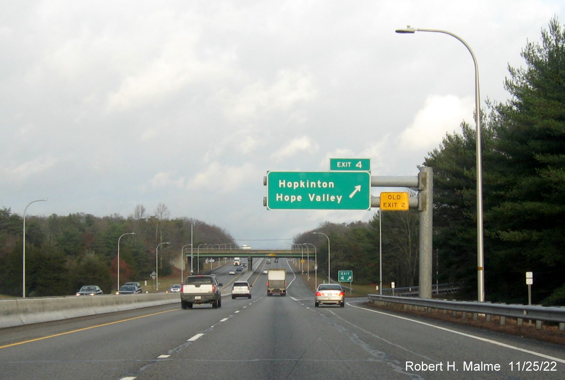 Image of ground mounted 1/2 mile advance sign for the Hopkinton exit with new milepost based exit numbers and yellow Old Exit 2 sign above exit tab on I-95 South, November 2022
