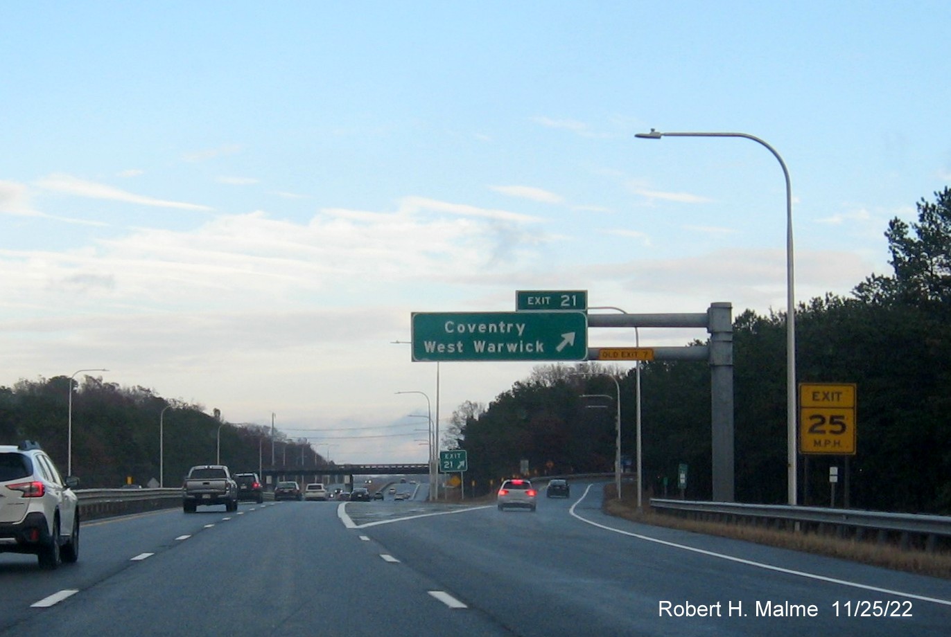 Image of overhead ramp sign for Coventry/West Warwick exit with new milepost based exit number and Old 
                                          Exit 7 sign on support post on I-95 North, November 2022