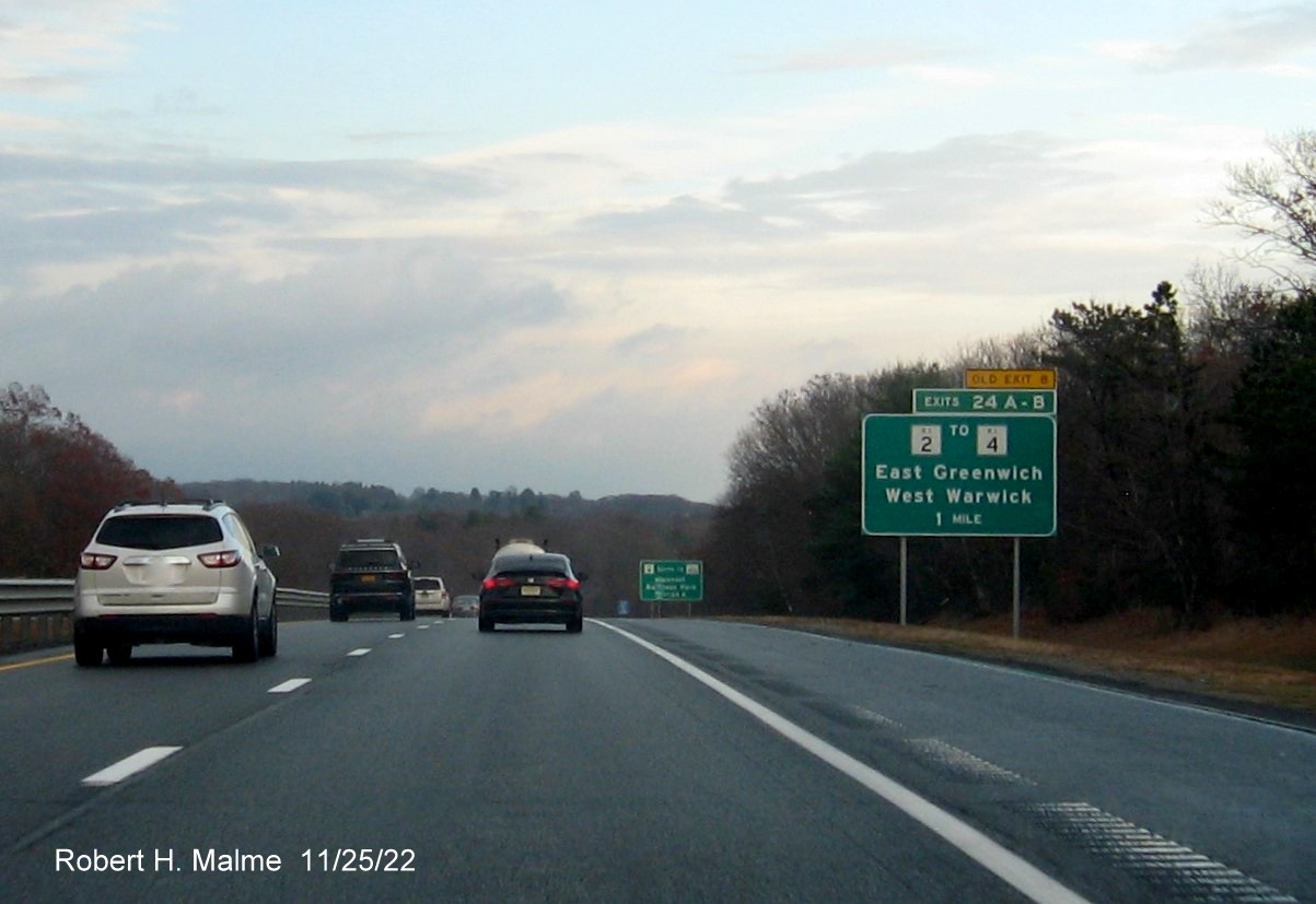 Image of ground mounted 1 mile advance sign for RI 2 to RI 4 exit with new milepost based exit number and yellow Old Exit 8 sign above exit tab on I-95 North in West Warwick, November 2022