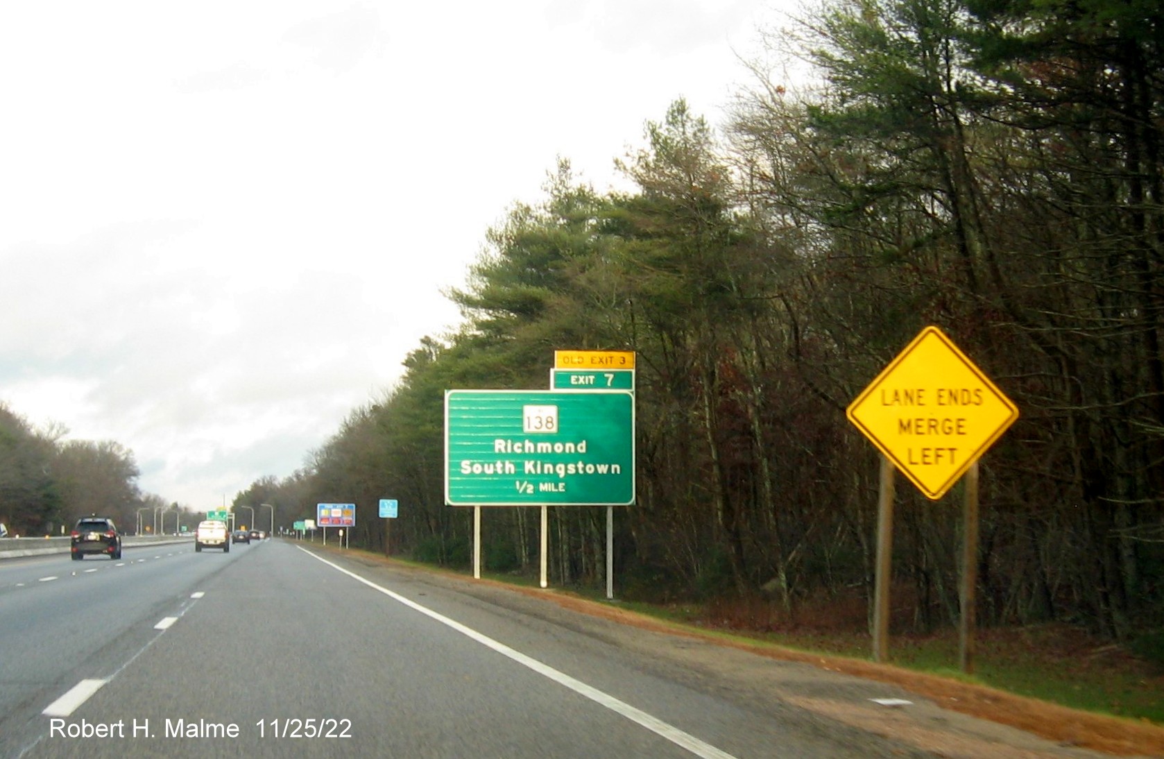 Image of ground mounted 1/2 mile advance sign for RI 138 exit with new milepost based exit number and 
                                         yellow Old Exit 3 sign above exit tab on I-95 North in Wyoming, November 2022