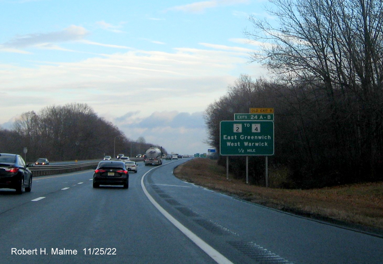 Image of ground mounted 1/2 mile advance sign for RI 2 to RI 4 exits with new milepost based exit numbers and yellow Old Exits 8 A-B sign above exit tab on I-95 North in West Warwick, November 2022