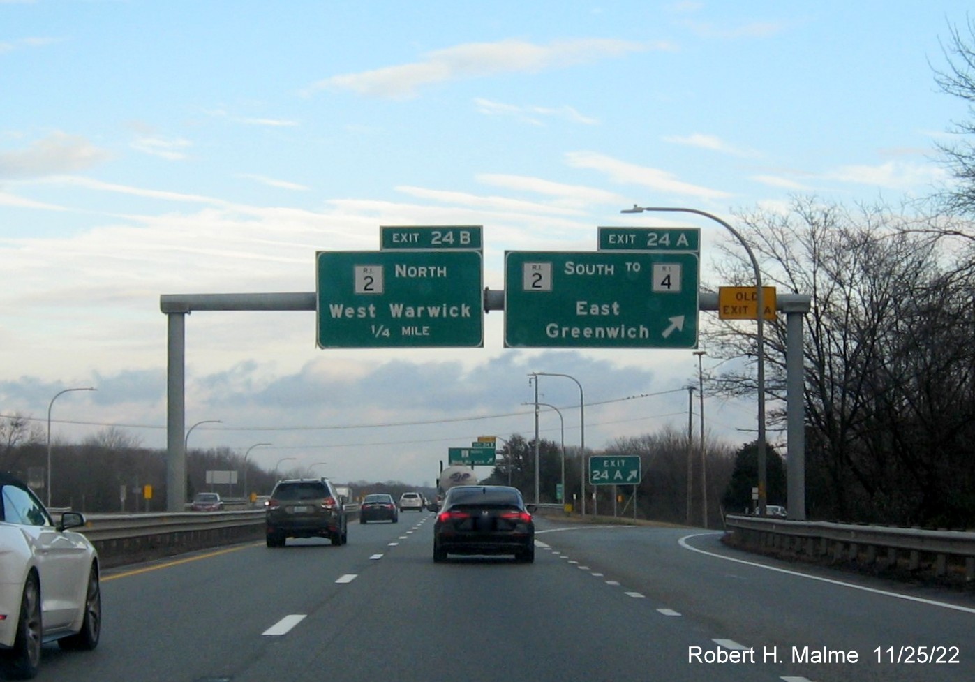 Image of overhead signage at ramp for RI 2 South to RI 4 exit with new milepost based exit number and yellow Old Exit 8 sign above exit tab on I-95 North in West Warwick, November 2022