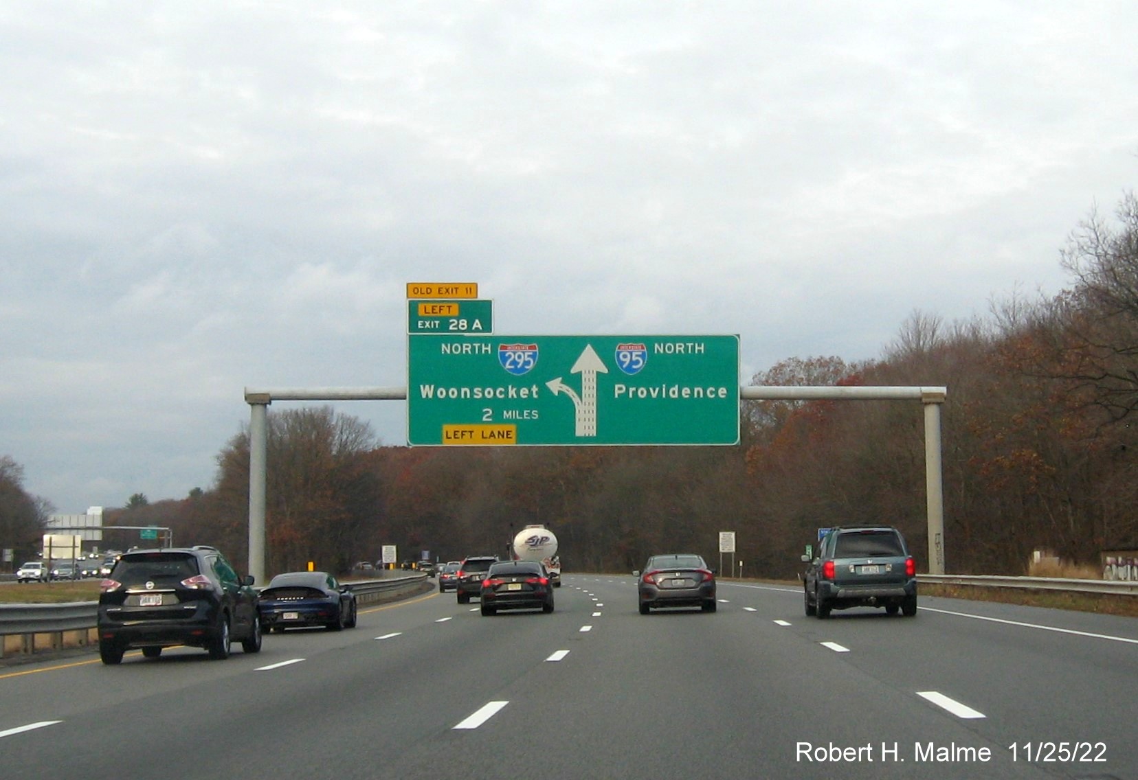 Image of overhead 2 miles advance diagrammatic sign for I-295 North exit with new milepost based exut number and yellow Old Exit 11 advisory sign above exit tab on I-95 North in Warwick, November 2022