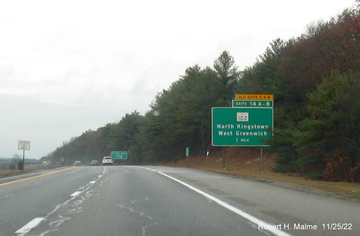 Image of ground mounted 1 mile advance sign for RI 102 exits with new milepost based exit numbers and yellow Old Exits 5 A-B advisory sign over exit tab on I-95 North in West Greenwich, November 2022