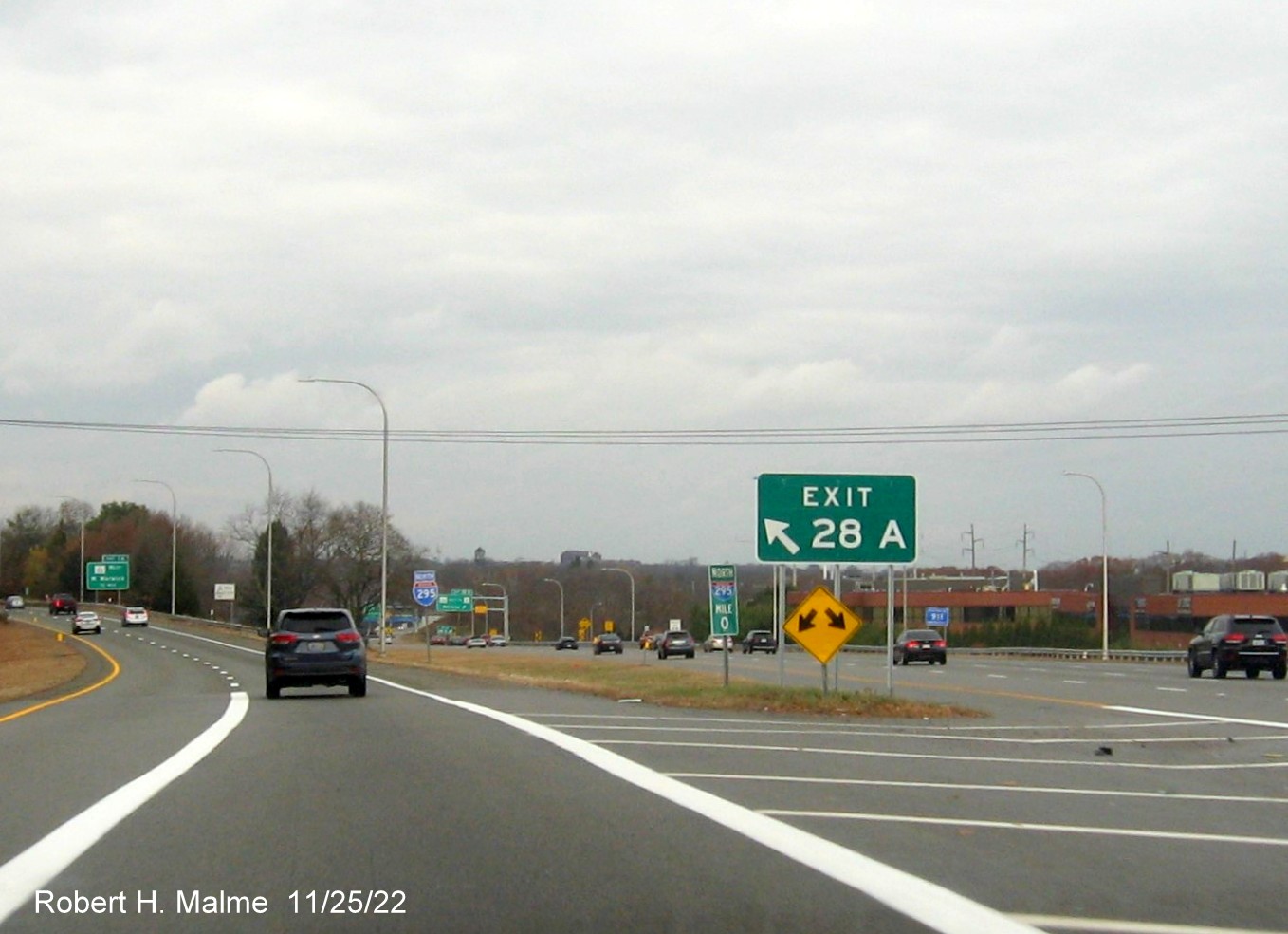 Image of gore sign for I-295 North exit with new milepost based exit number and yellow Old Exit 11 advisory sign above exit tab on I-95 North in Warwick, November 2022