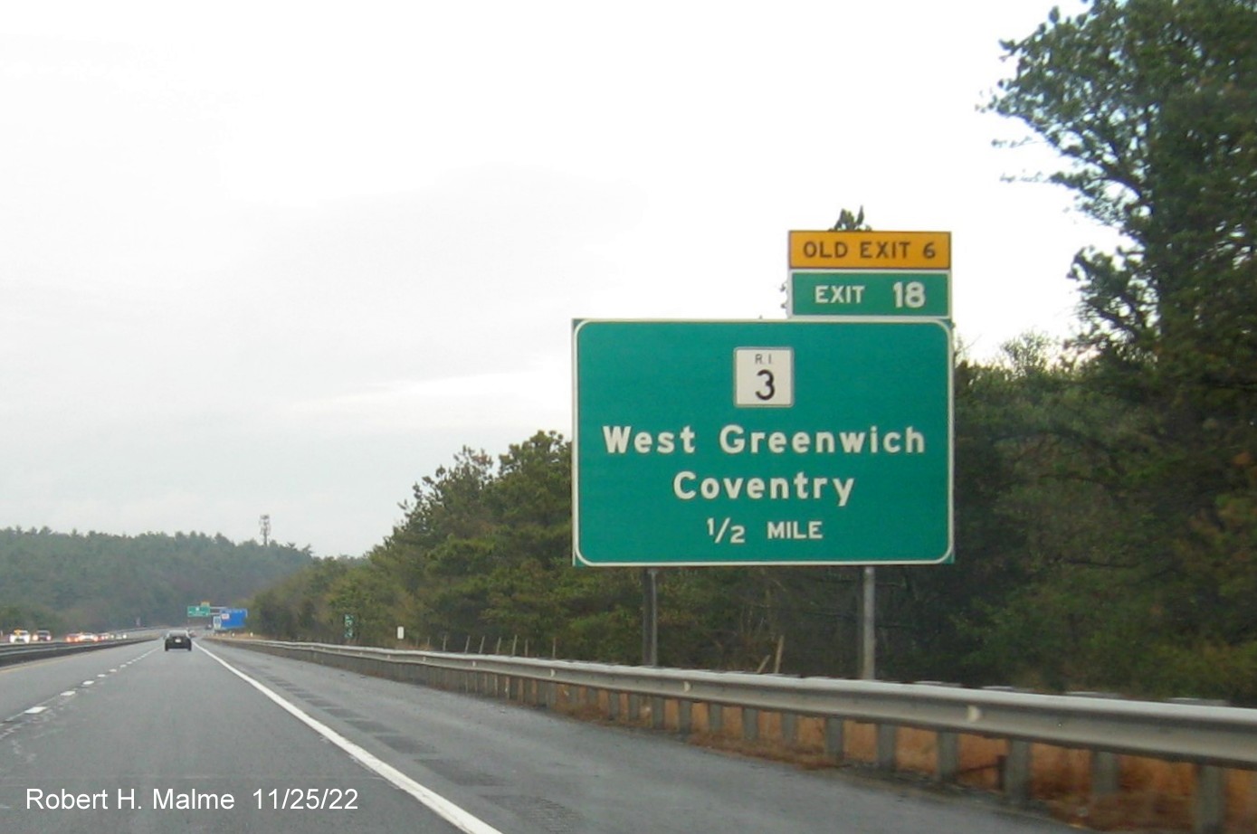 Image of ground mounted 1/2 mile advance sign for RI 3 exit with new milepost based exit number and yellow Old Exit 6 advisory sign above exit tab on I-95 North in West Greenwich, November 2022