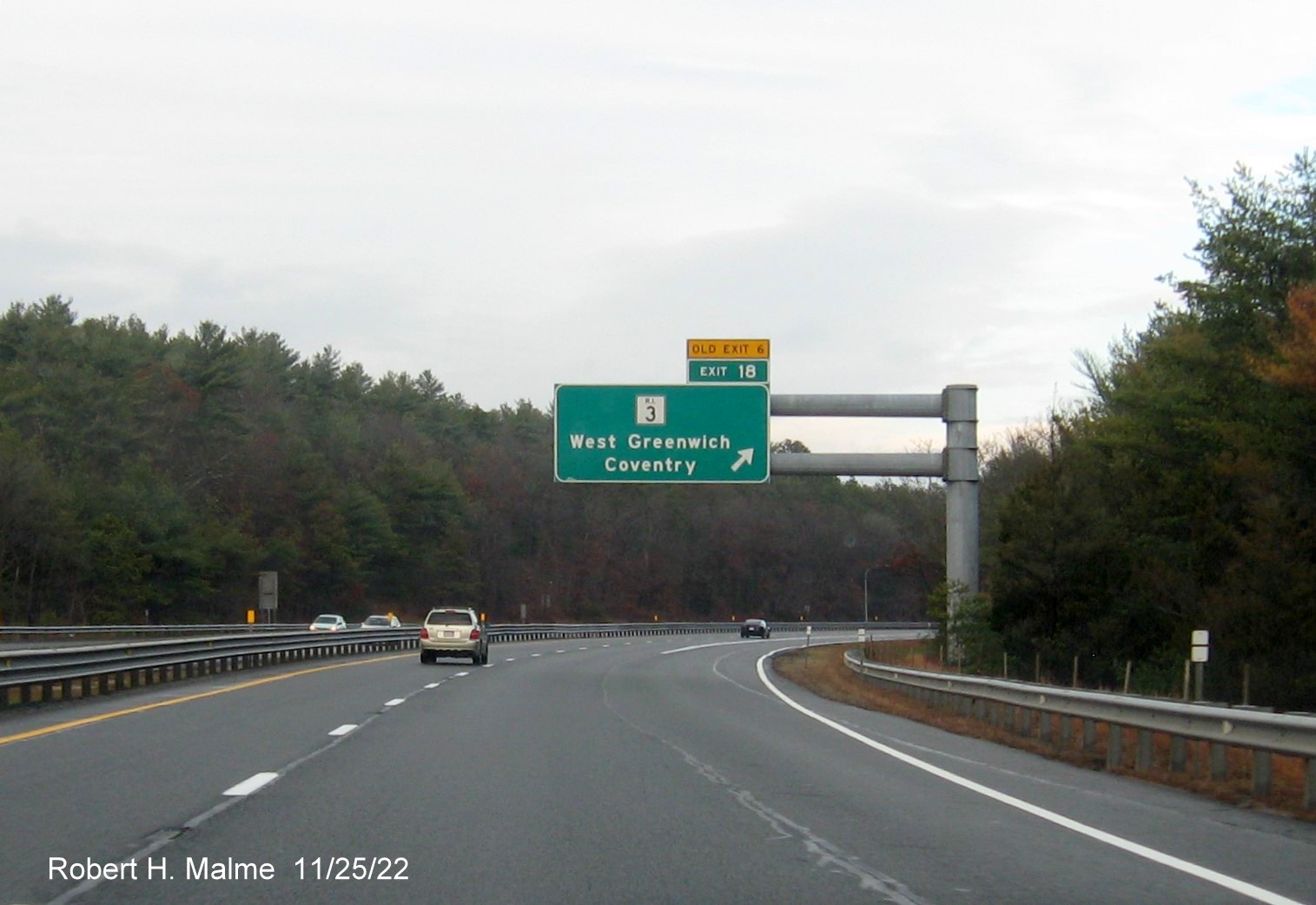 Image of overhead ramp sign for RI 3 exit with new milepost based exit number and yellow Old Exit 6 advisory sign above exit tab on I-95 North in West Greenwich, November 2022