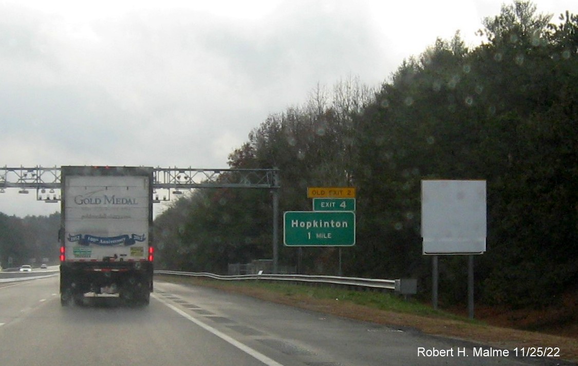 Image of ground mounted 1 mile advance sign for the Hopkinton exit with new milepost based exit number and yellow Old Exit 2 sign above exit tab on I-95 South, November 2022