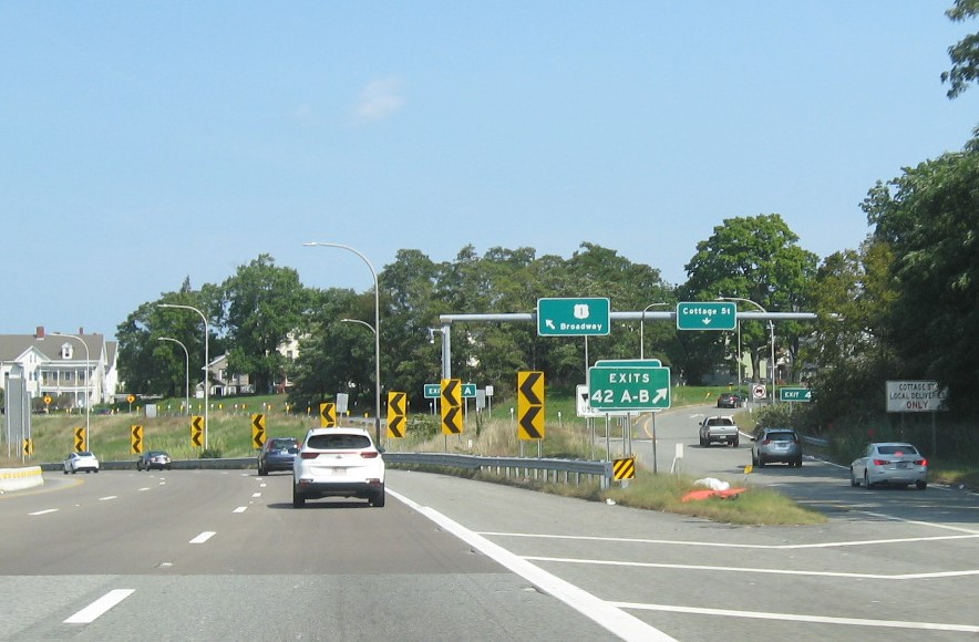 Image of gore sign for US 1 Broadway exit with new milepost based exit number and yellow Old Exit 29 sign below on I-95 North in Pawtucket, September 2022