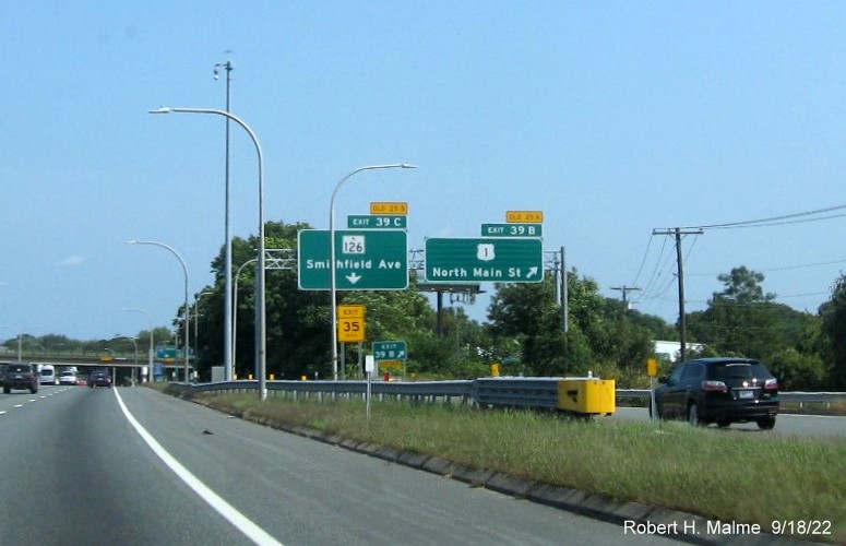 Image of overhead ramp signs for US 1/RI 126 exits with new milepost based exit numbers and yellow Old Exit 25A and 25B tabs on top on I-95 North in Providence, September 2022