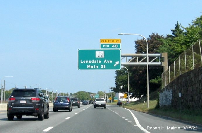 Image of 1/2 mile advance overhead sign for Downtown Pawtucket exit with new milepost based exit number on I-95 North and yellow Old Exit 27 sign below, September 2022