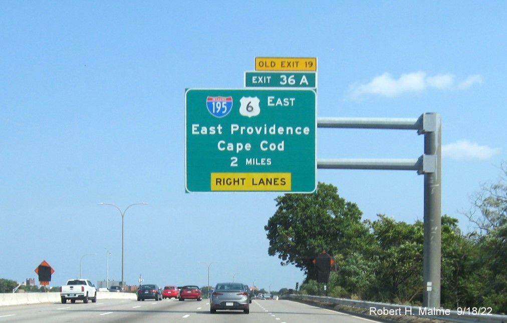 Image of 2 miles advance overhead sign for I-195/US 6 East exit with new milepost based exit number and yellow Old Exit 19 sign on top of exit tab on I-95 North in Providence, September 2022
