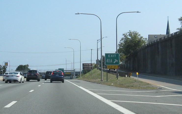 Image of gore sign for Downtown Pawtucket exit with new milepost based exit number on I-95 North and yellow Old Exit 27 sign below, September 2022