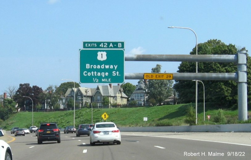 Image of 1/2 mile advance overhead sign for US 1 Broadway exit with new milepost based exit number and yellow Old Exit 29 sign on gantry arm on I-95 North in Pawtucket, September 2022