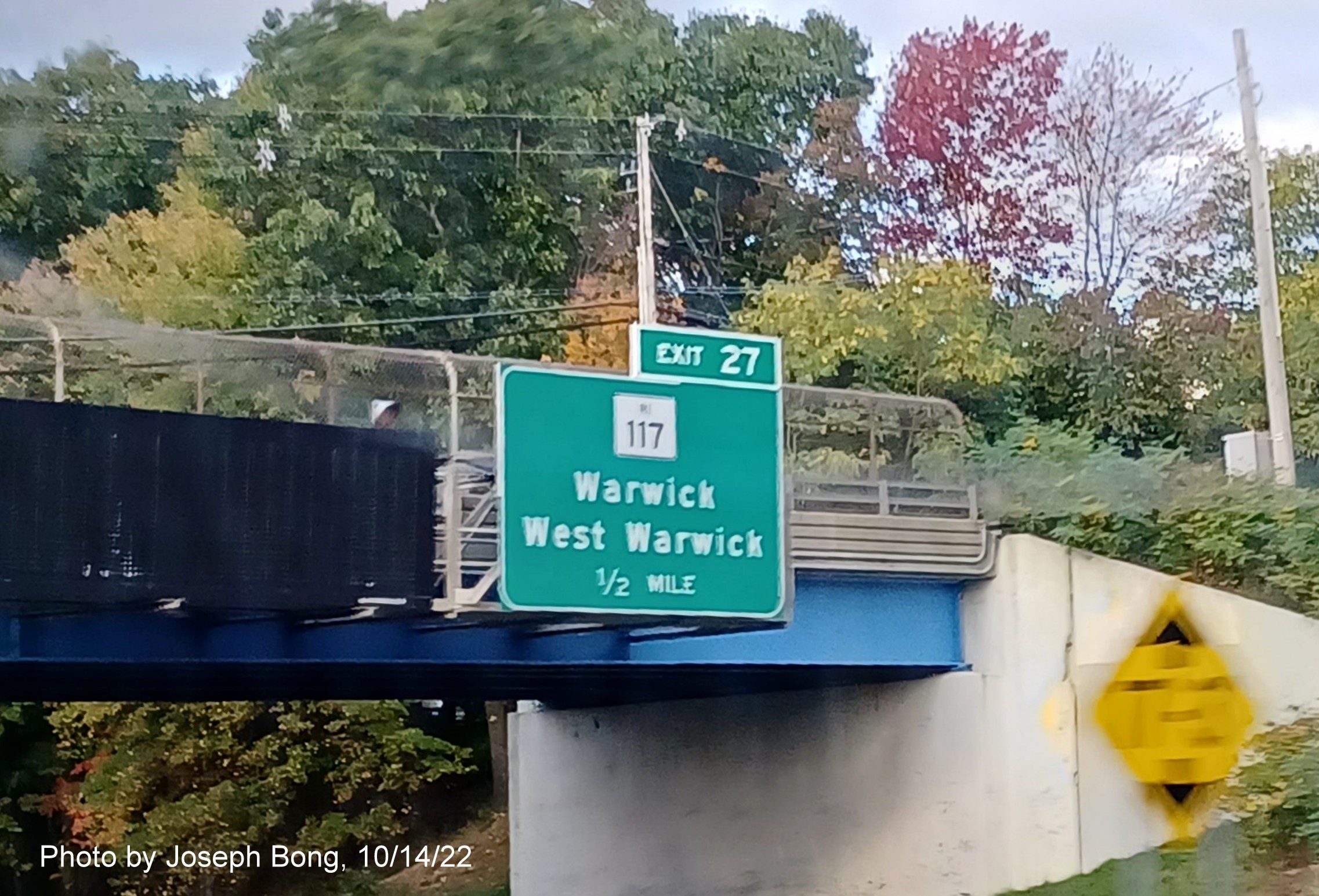 Image of bridge mounted 1/2 mile advance sign for RI 117 exit with new milepost based exit number on I-95 North in Warwick, photo by Joseph Bong, October 2022