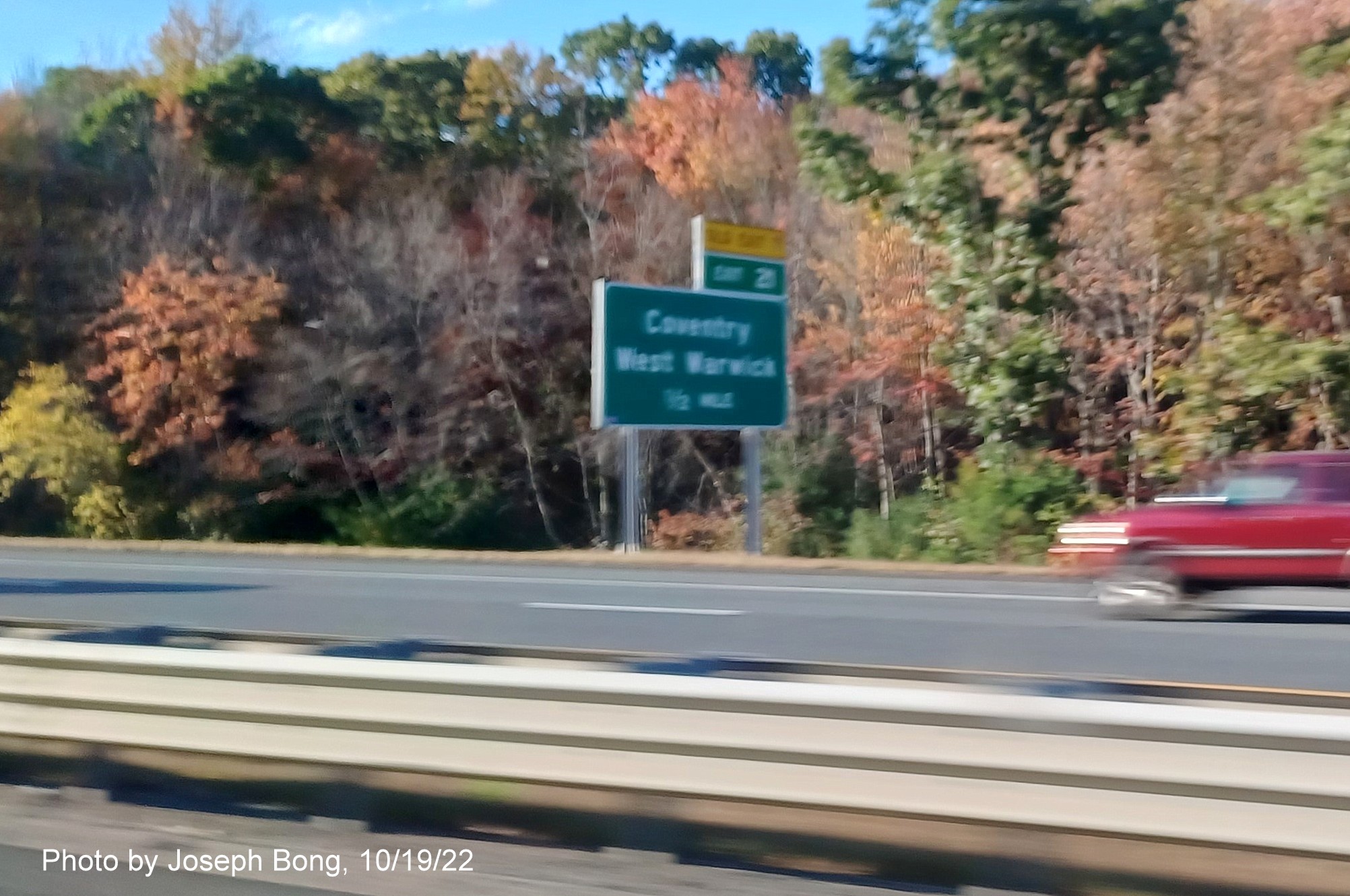 Image of 1/2 mile advance sign for Coventry/West Warwick exit with new milepost based exit number and yellow Old Exit 7 sign over exit tab on I-95 South,  by Joseph Bong, October 2022