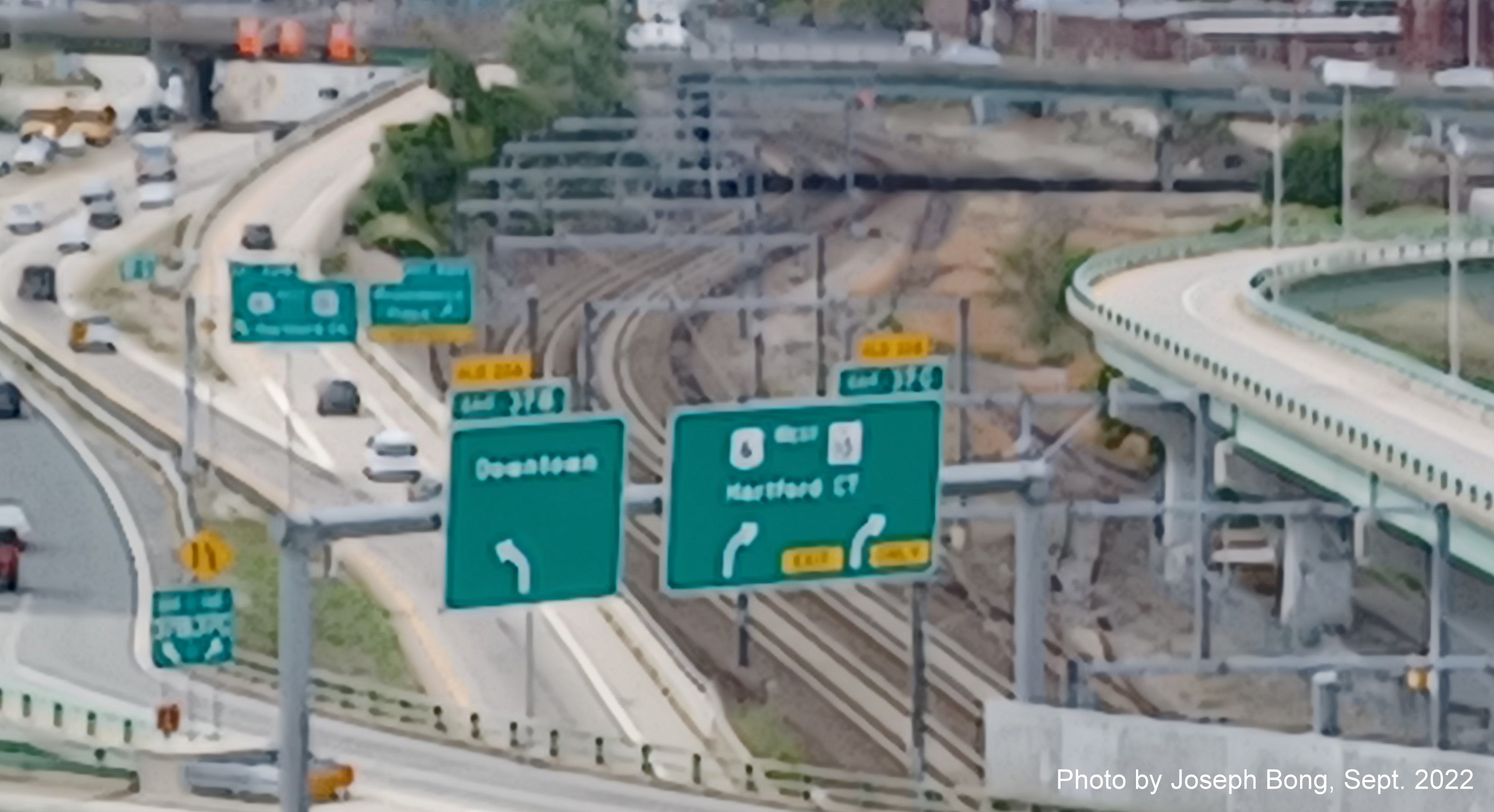 Image of overhead signs for Downtown and US 6 West/RI 10 exits with new milepost based exit numbers,
                                         by Joseph Bong, September 2022