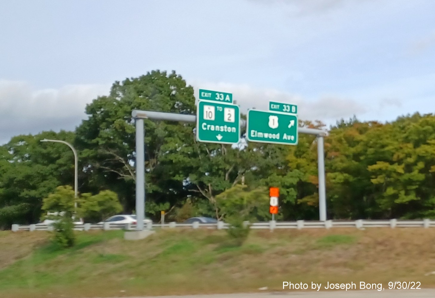 Image of ramp signage for RI 10/US 1 exit with new milepost based exit numbers off of I-95 South in Providence, by Joseph Bong, August 2022