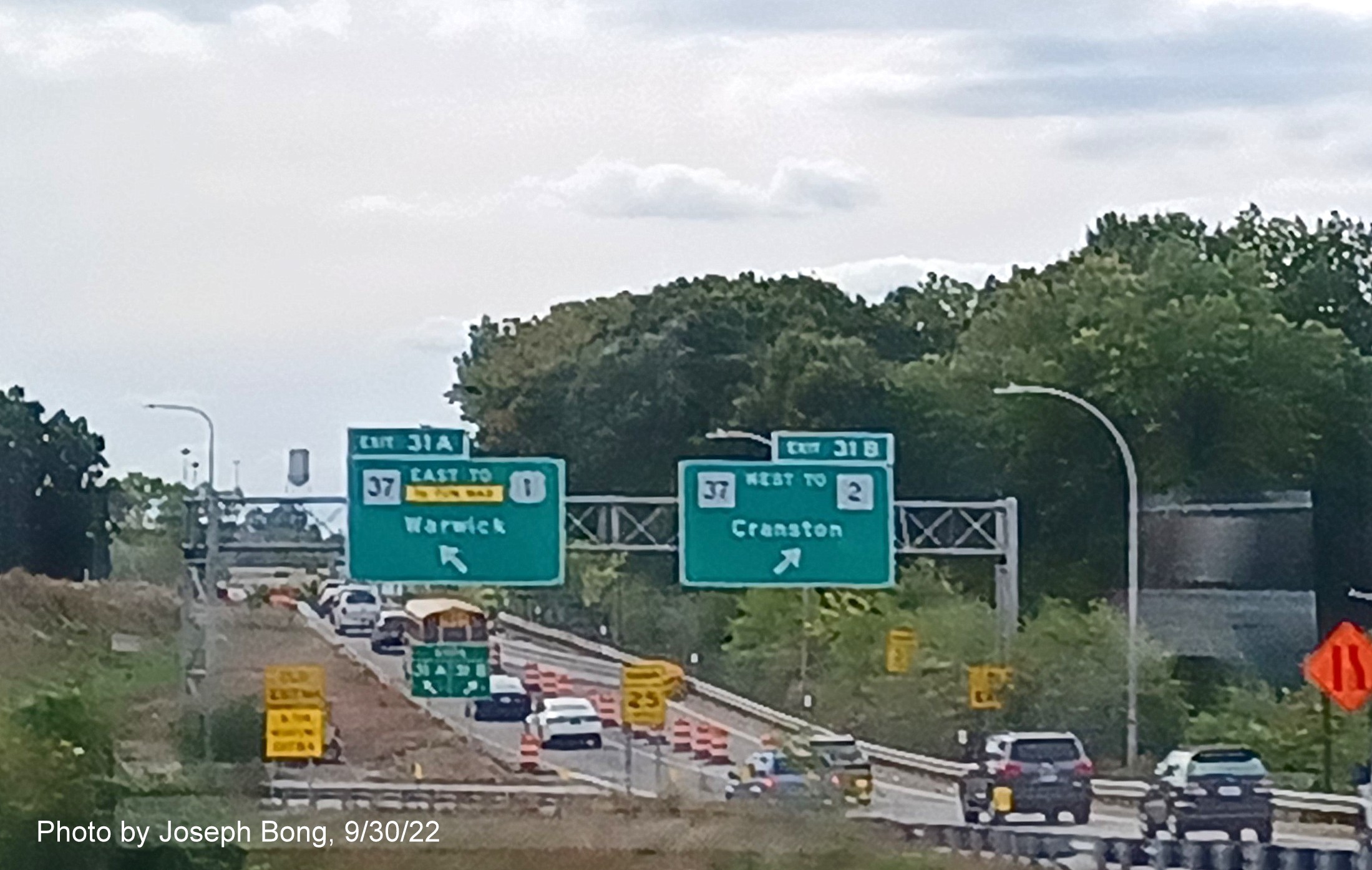 Image of overhead ramp signage from I-95 South in Cranston for RI 37 exits with new milepost based exit numbers and separate yellow Old Exit 15 A/B sign below, photo by Joseph Bong, September 2022