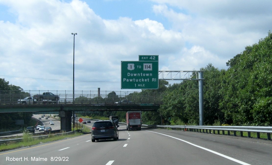 Image of recently placed 1 mile advance overhead sign for US 1 to RI 114 exit with new milepost based exit number on I-95 South in Attleboro, MA, August 2022