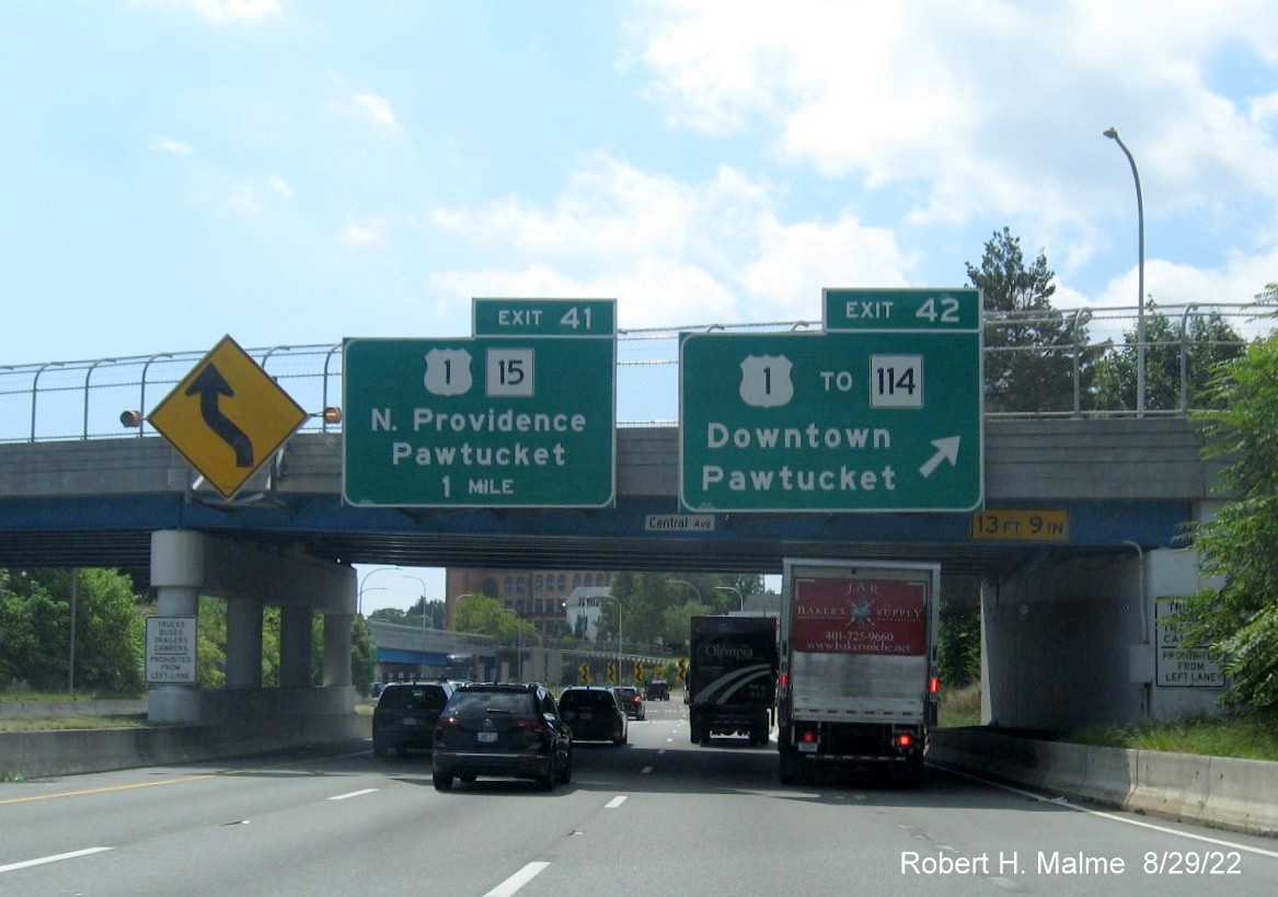 Image of overhead signsge for US 1/RI 15 and US 1 to RI 114 exits with new milepost based exit number 
        on I-95 South in Pawtucket, August 2022
