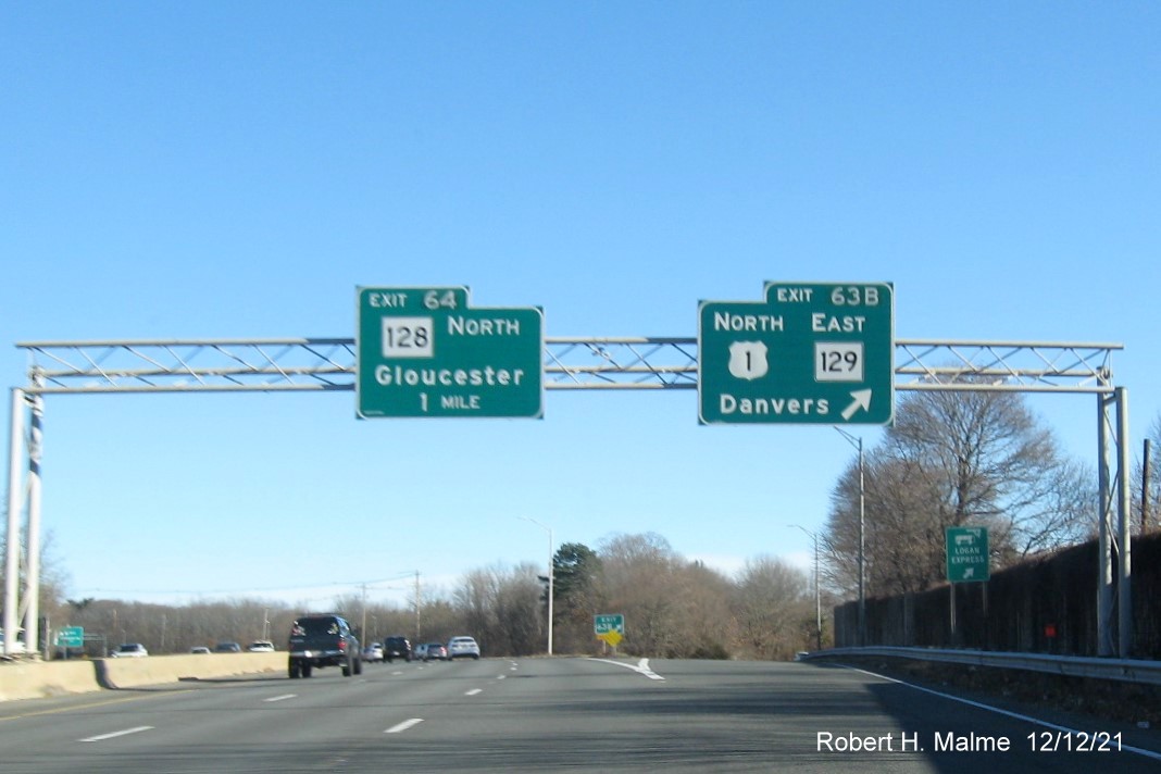 Image of overhead signs at ramp to US 1 North/MA 129 East exit with new milepost based exit numbers, December 2021