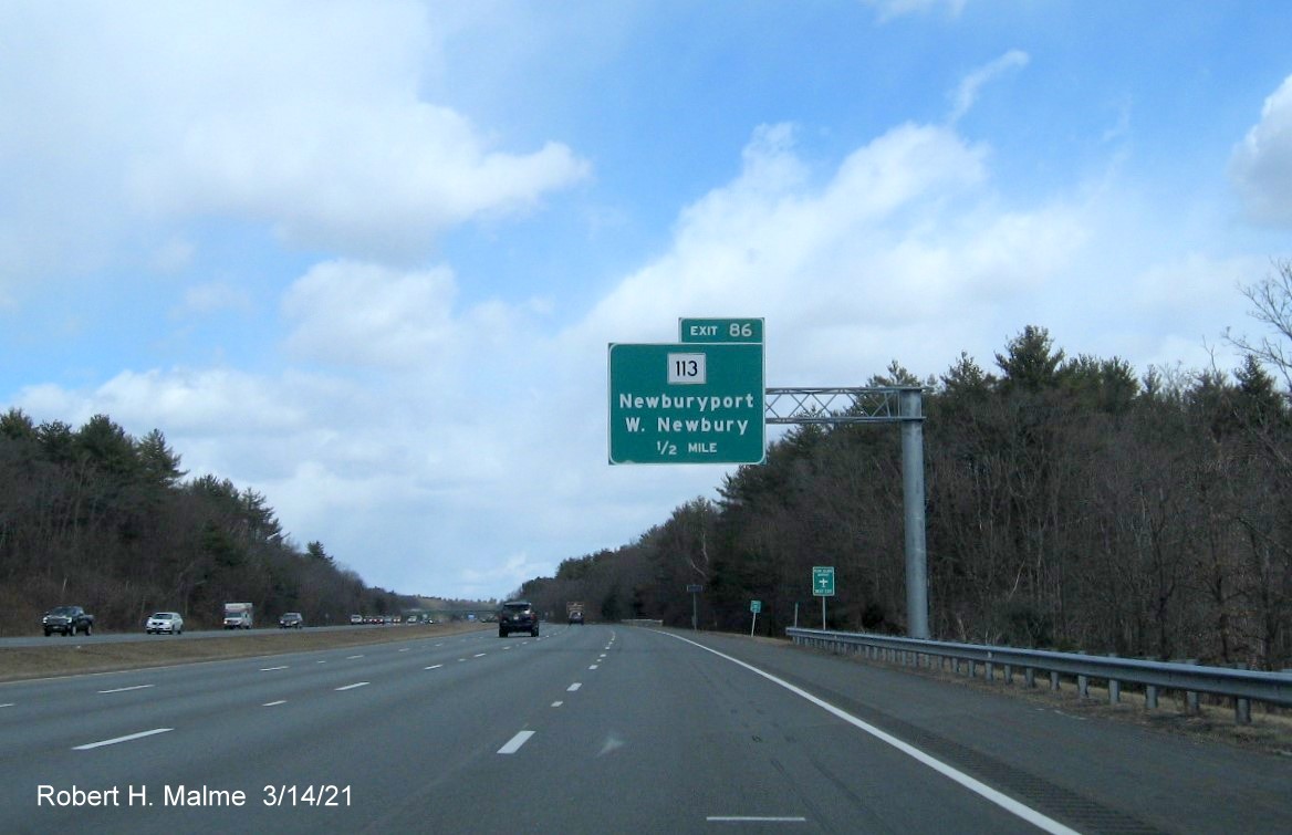 Image of 1/2 mile advance overhead sign for MA 113 exit with new milepost based exit number on I-95 North in Newburyport, March 2021