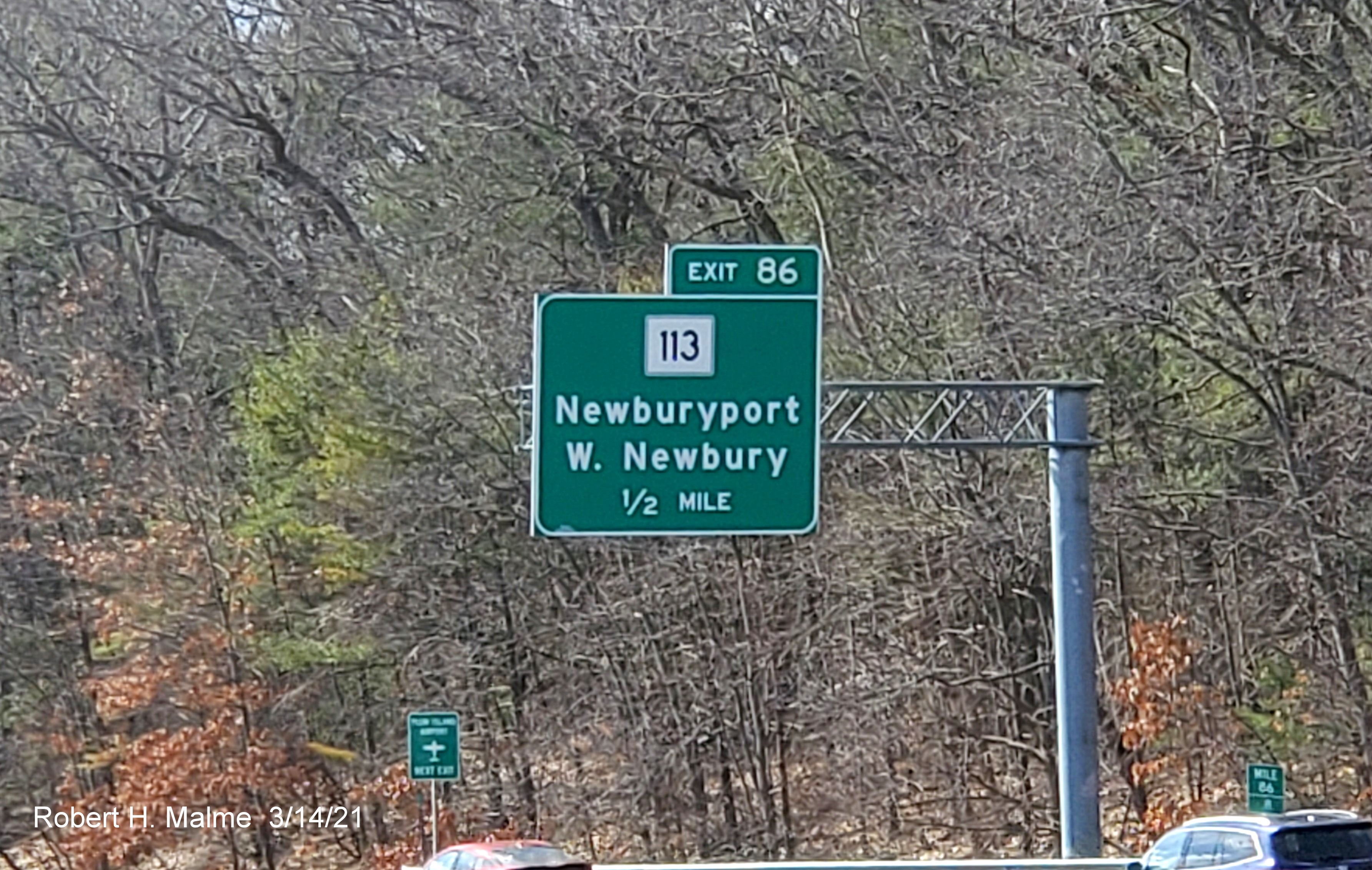 Image of 1/2 mile advance overhead sign for MA 113 exit with new milepost based exit number on I-95 South in Newburyport, March 2021