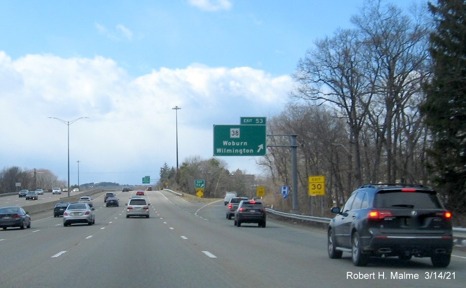 Image of overhead ramp sign for MA 38 exit with new milepost based exit number on I-95/MA 128 South in Woburn, March 2021