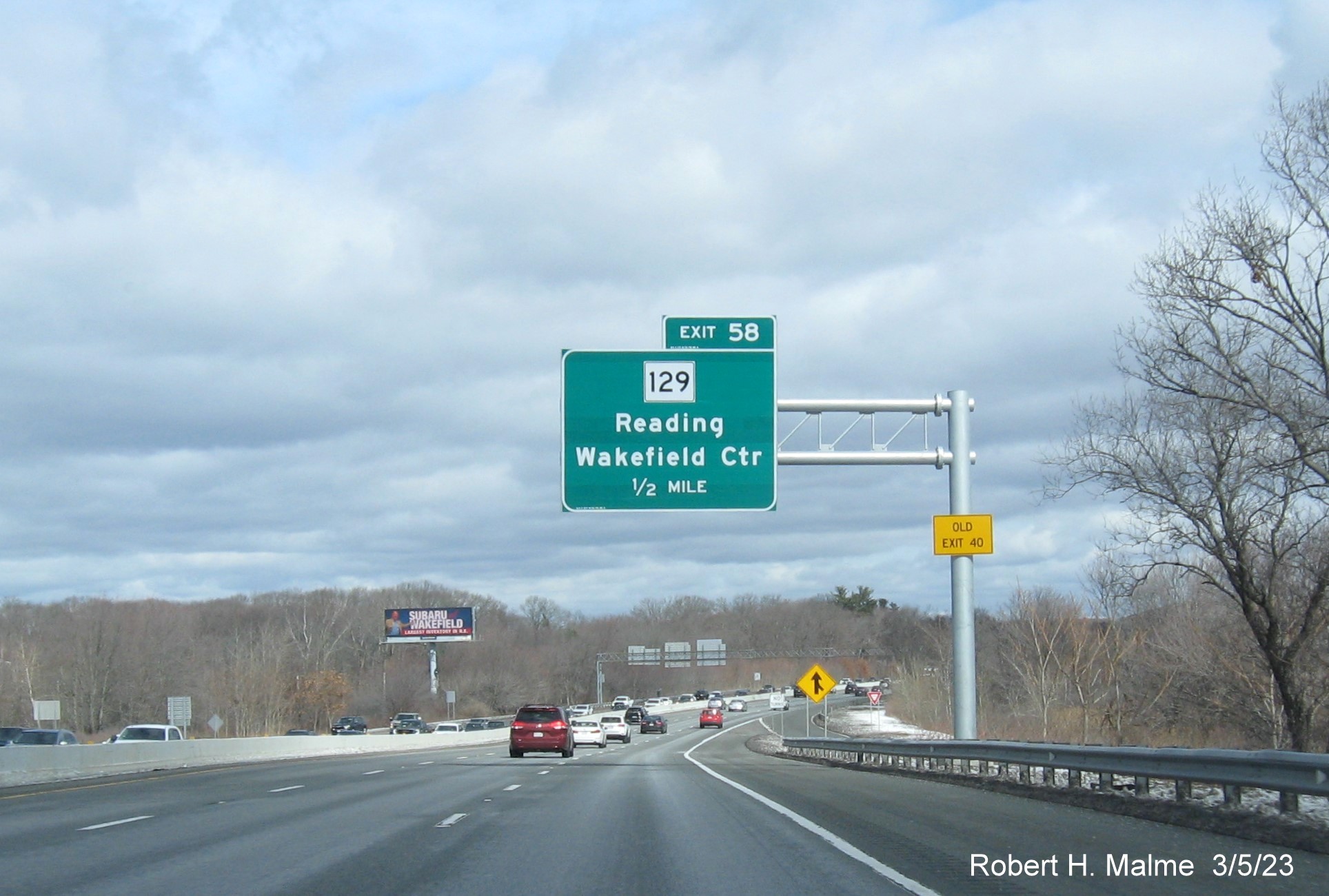 Image of recently placed 1/2 mile advance overhead sign for MA 129 exit on
                                     I-95/MA 128 North in Wakefield, March 2023