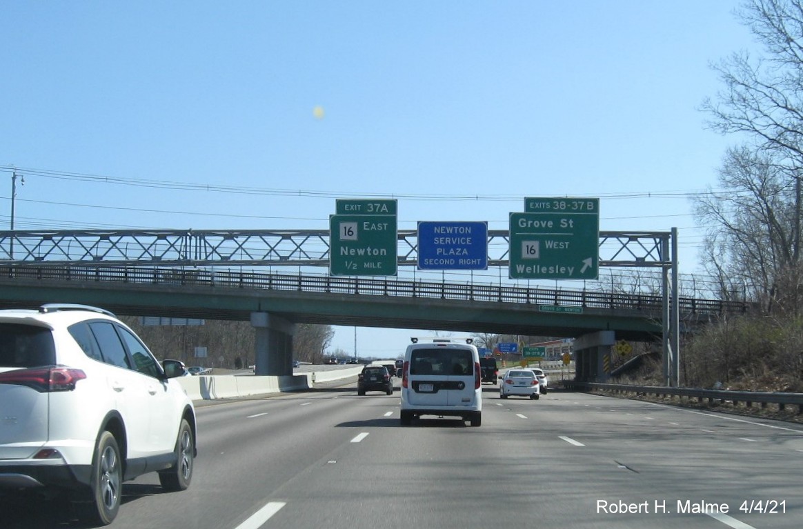 Image of overhead signs at ramp for MA 16 West/Grove Street exits with new milepost based exit numbers on I-95/MA 128 South in Newton, April 2021