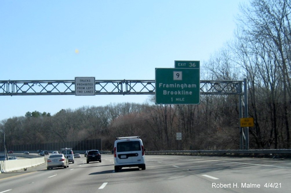 Image of 1 Mile advance overhead sign for MA 9 exit with wrong number tab and new milepost based exit number and yellow Old Exit 20 advisory sign on right support on I-95/MA 128 South in Wellesley, April 2021