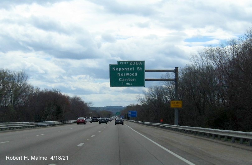 Image of 1 Mile advance sign for Neponset Street exits with new milepost based exit numbers and yellow Old Exits 11 B-A advisory sign on support on I-95 South in Canton, April 2021