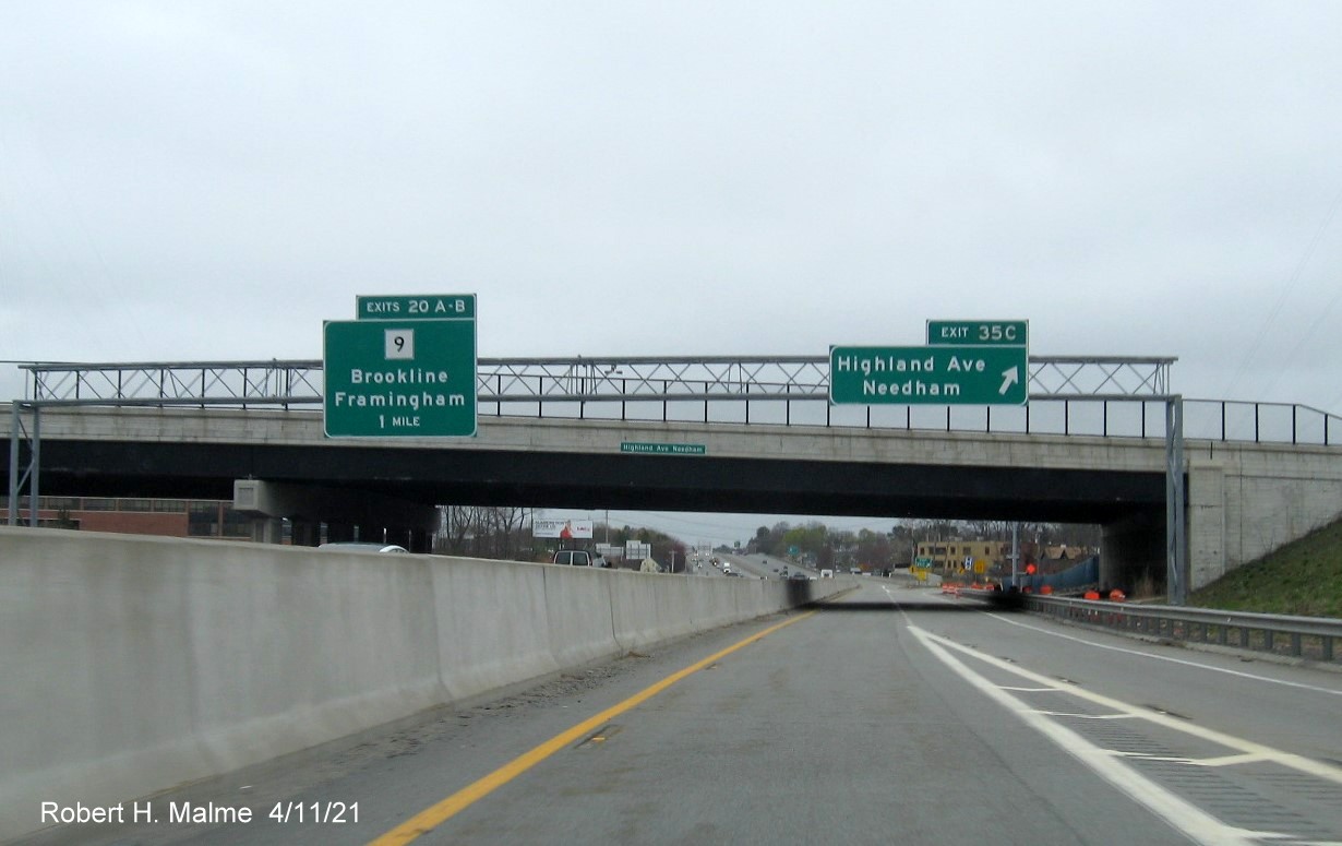 Image of overhead ramp sign for Highland Avenue West exit with new milepost 
                                            based exit numbers on C/D ramp from I-95/MA 128 North in Needham, April 2021