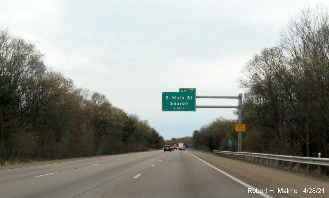 Image of 1 mile advance overhead sign for South Main Street exit with new milepost based exit number and yellow Old Exit 8 advisory sign on support on I-95 North in Foxboro, April 2021