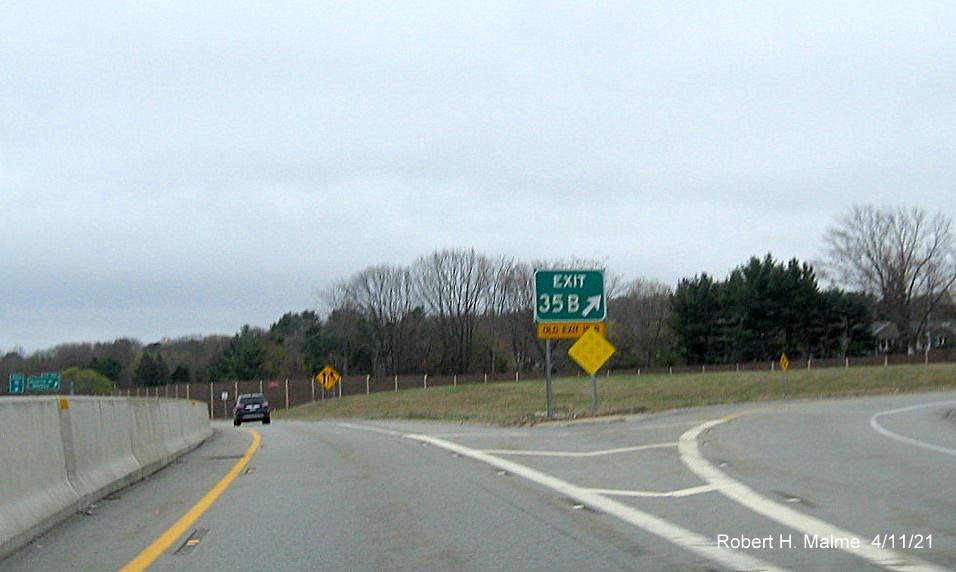 Image of gore sign for Highland Avenue East exit with new milepost based 
                                            exit number on C/D ramp from I-95/MA 128 South in Needham, April 2021