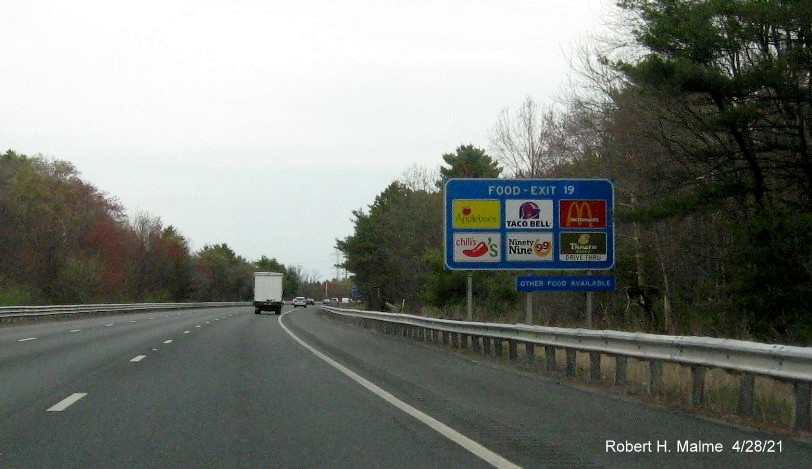 Image of blue Food Services sign for US 1 to MA 27 exit with new milepost based exit number on I-95 North in Walpole, April 2021